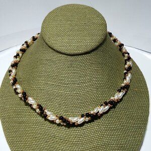 Women`s gold tone faux pearl twist bead necklace.
